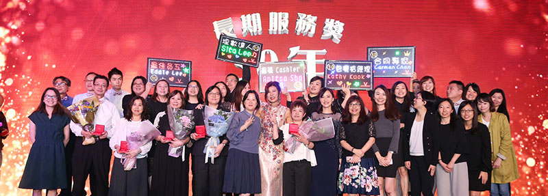 HML’s staff celebrating on the stage with colleagues receiving the long service award